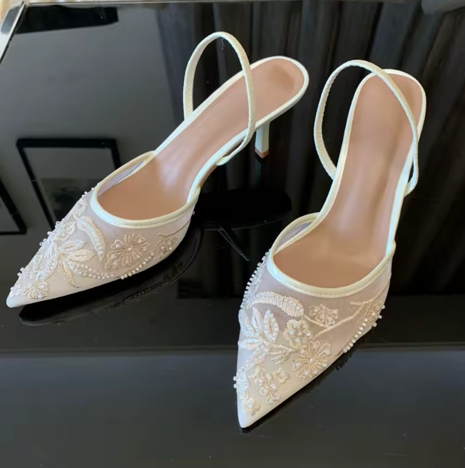 Beige mesh mule heels with floral embroidery and pearl trim, pointed toe