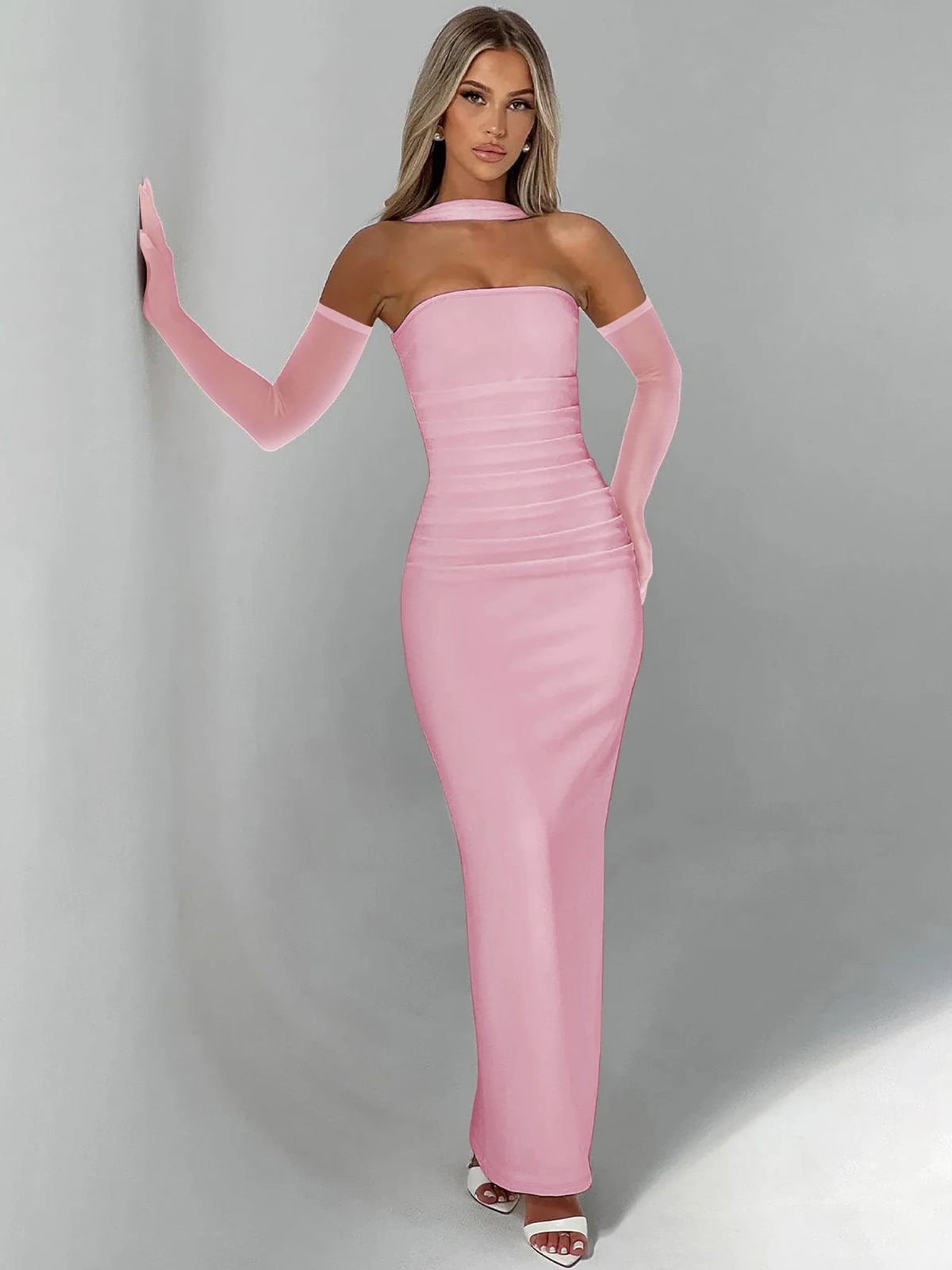 Pink strapless bodycon maxi dress with sheer long mesh sleeves and draped scarf.