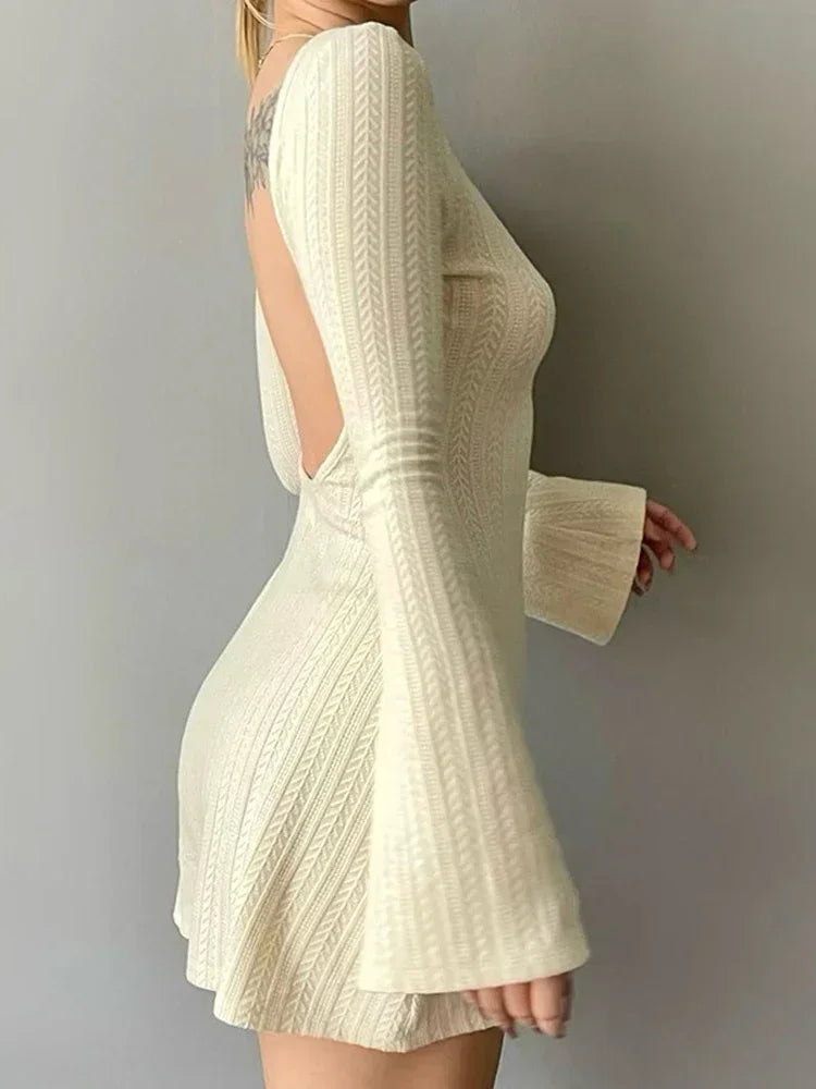 Cream knit mini dress with open back and flared skirt with short flare sleeves