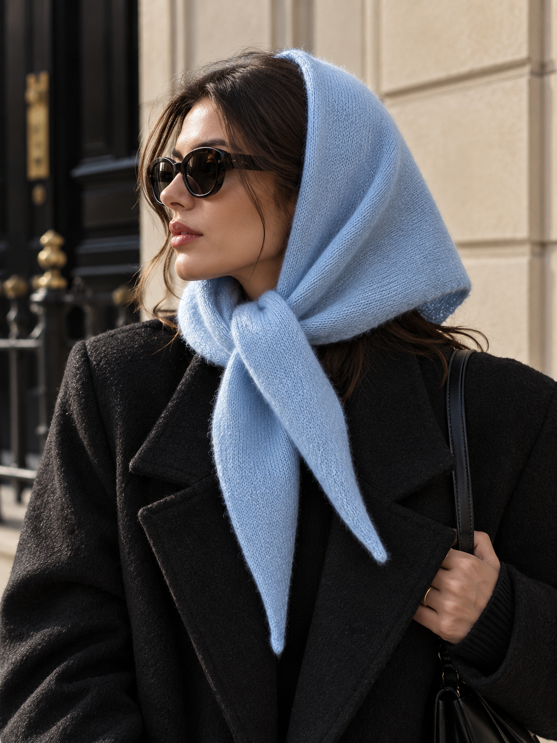 Long wool wrap scarf in light blue, draped over the neck with tied ends