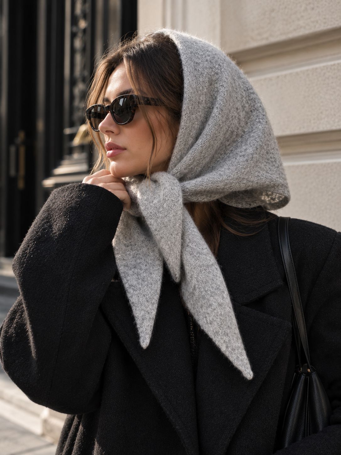 Long wool wrap scarf in light grey, tucked at the neck with pointed ends
