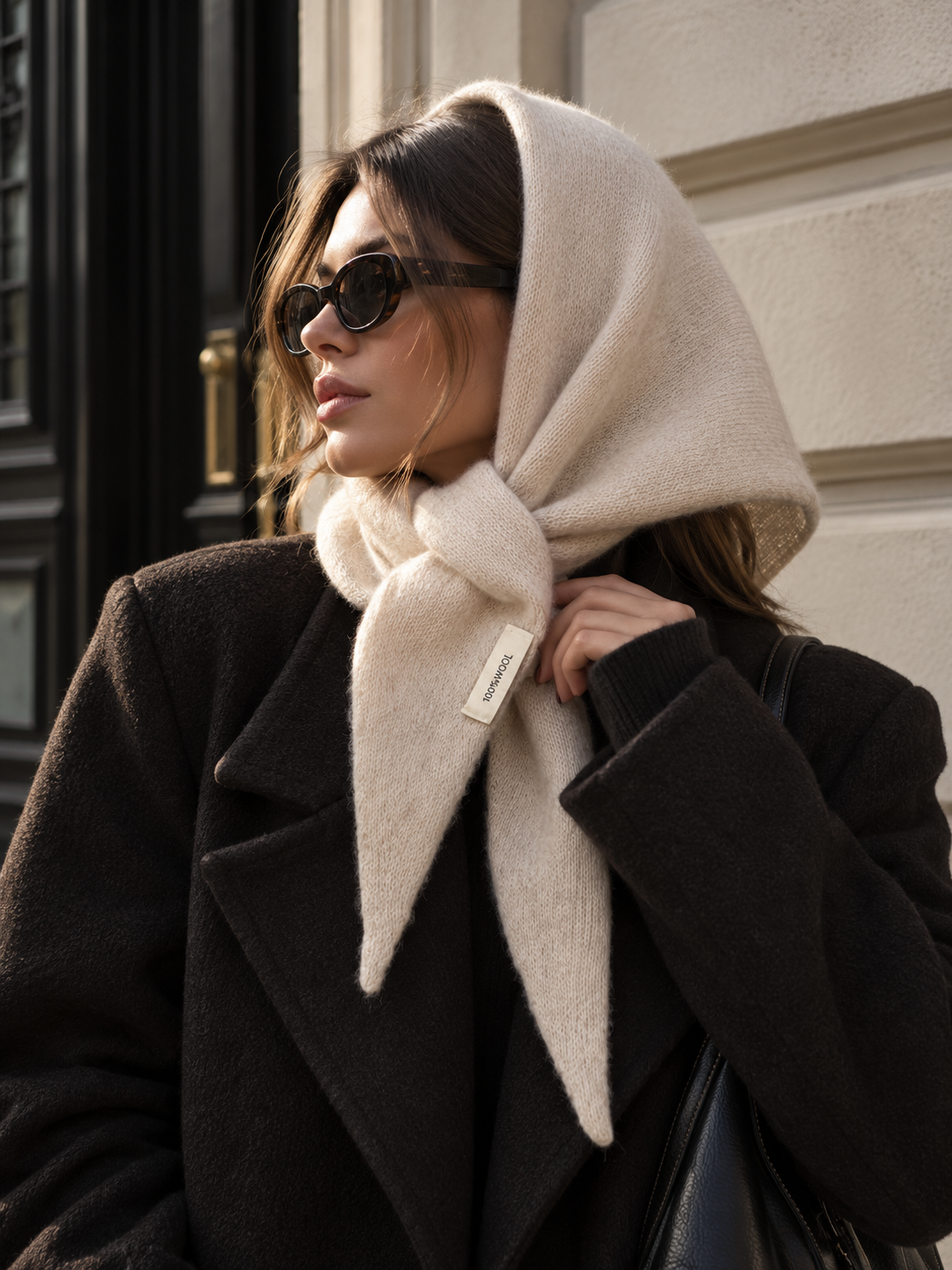 Long wool wrap scarf in light beige, wrapped around the neck with tassel-like ends