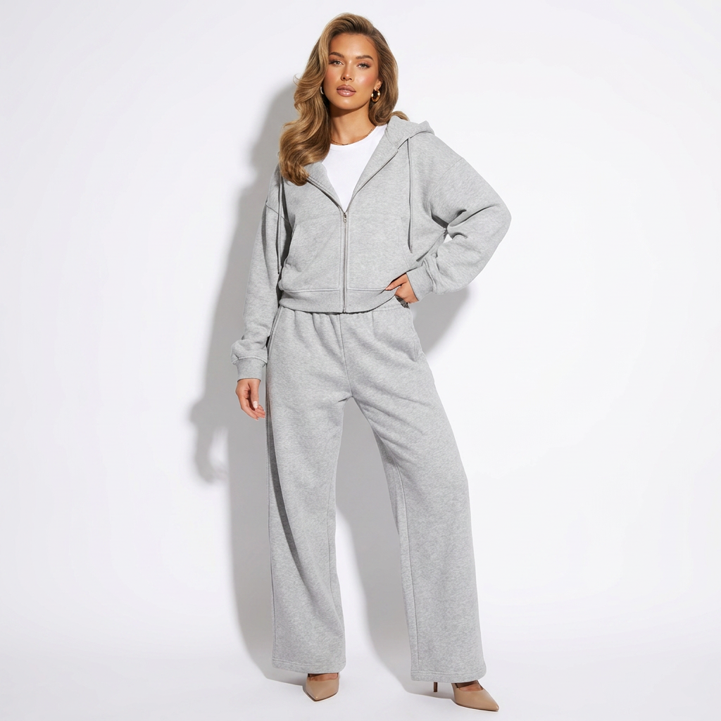 Grey zip-up hoodie and wide-leg jogger set with hood and drawstring waist.