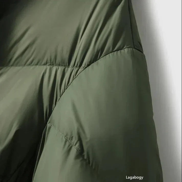 Green down puffer coat with chevron quilting seam detail near chest