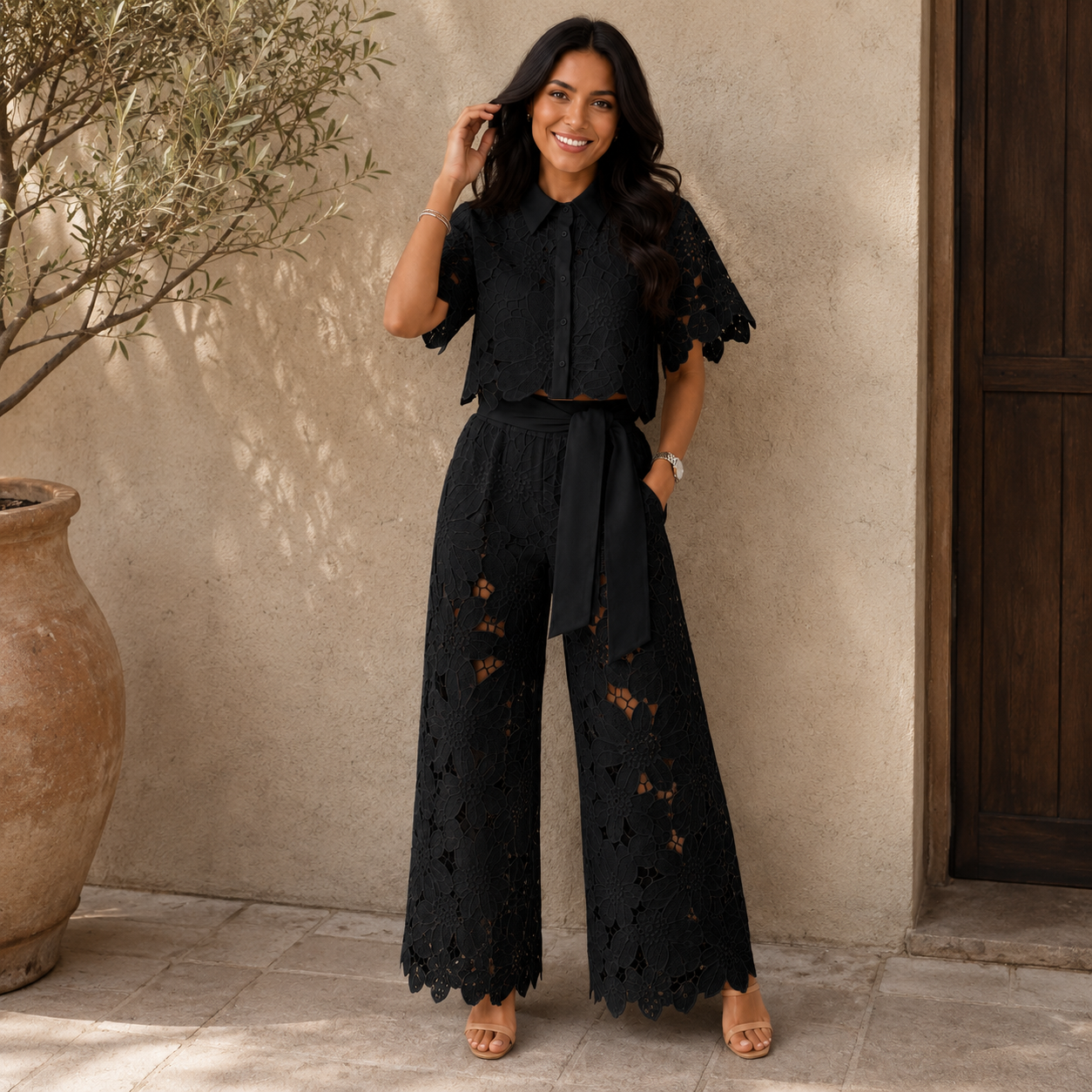 Black lace two-piece set: short-sleeve blouse and wide-leg pants with waist tie.