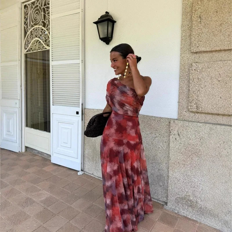 Red and maroon tie-dye one-shoulder sheath maxi dress with ruched bodice