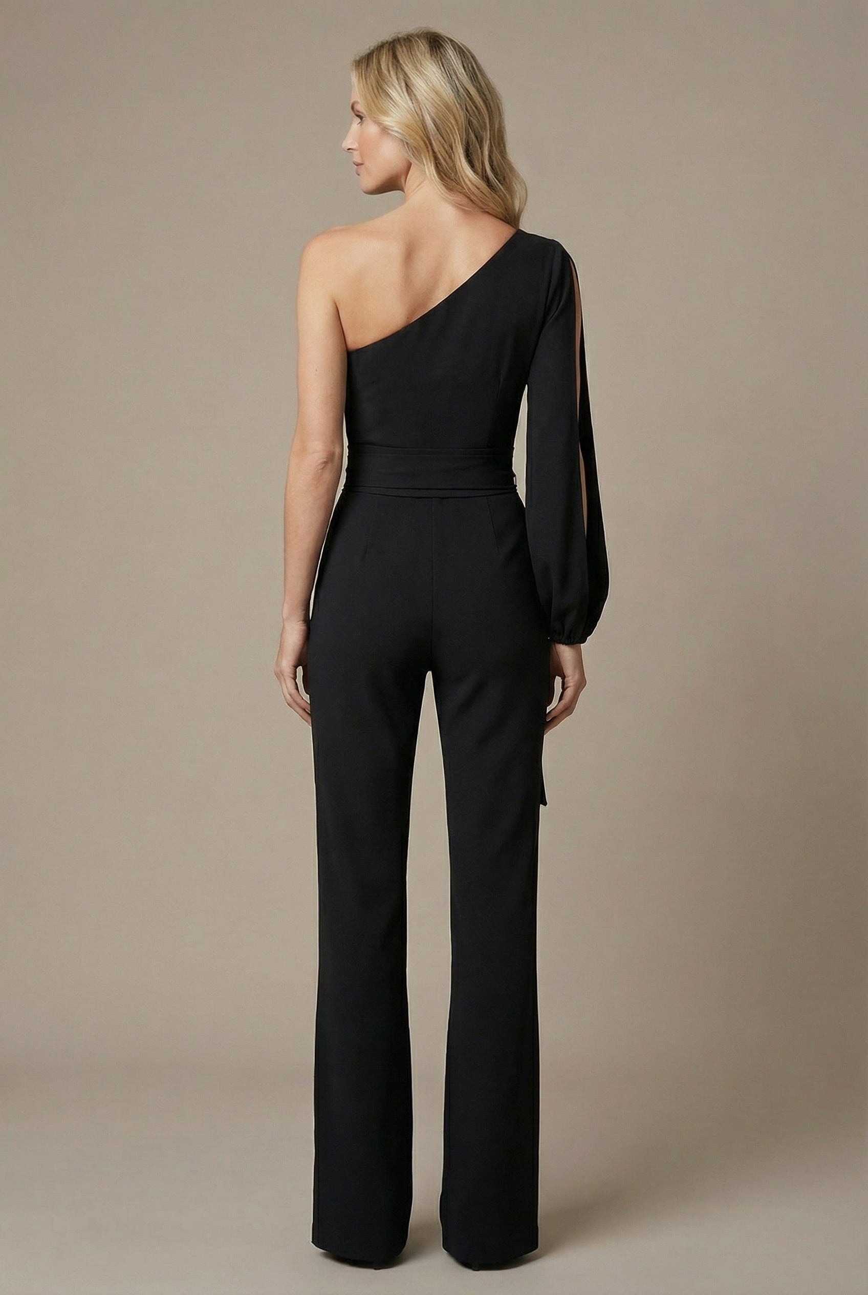 Women’s black one-shoulder wide-leg jumpsuit, side view with draped long sleeve