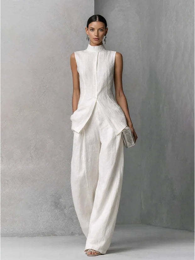 White linen sleeveless top with high neck drape and matching wide-leg trousers set