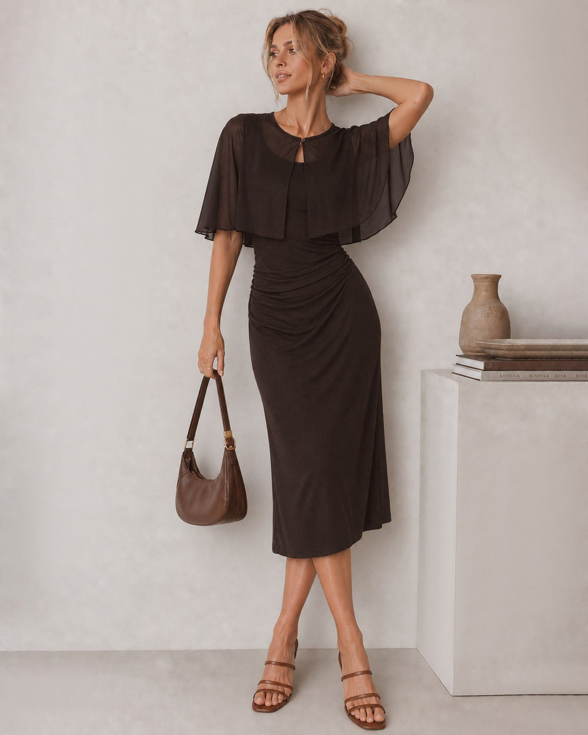 Dark brown midi dress with U-neck, draped waist, and cape-style short sleeves